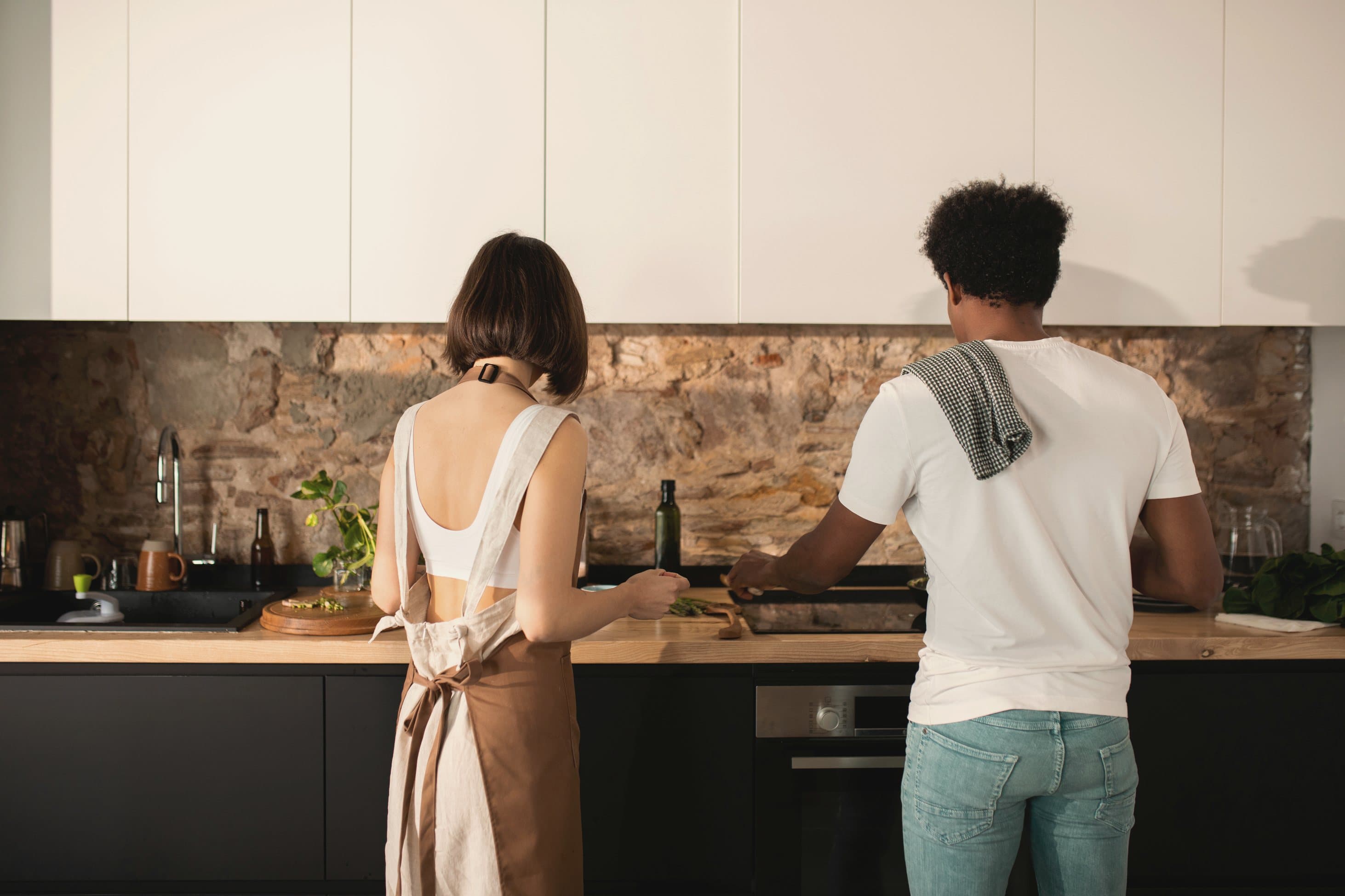 A couple cooking together in a modern home kitchen