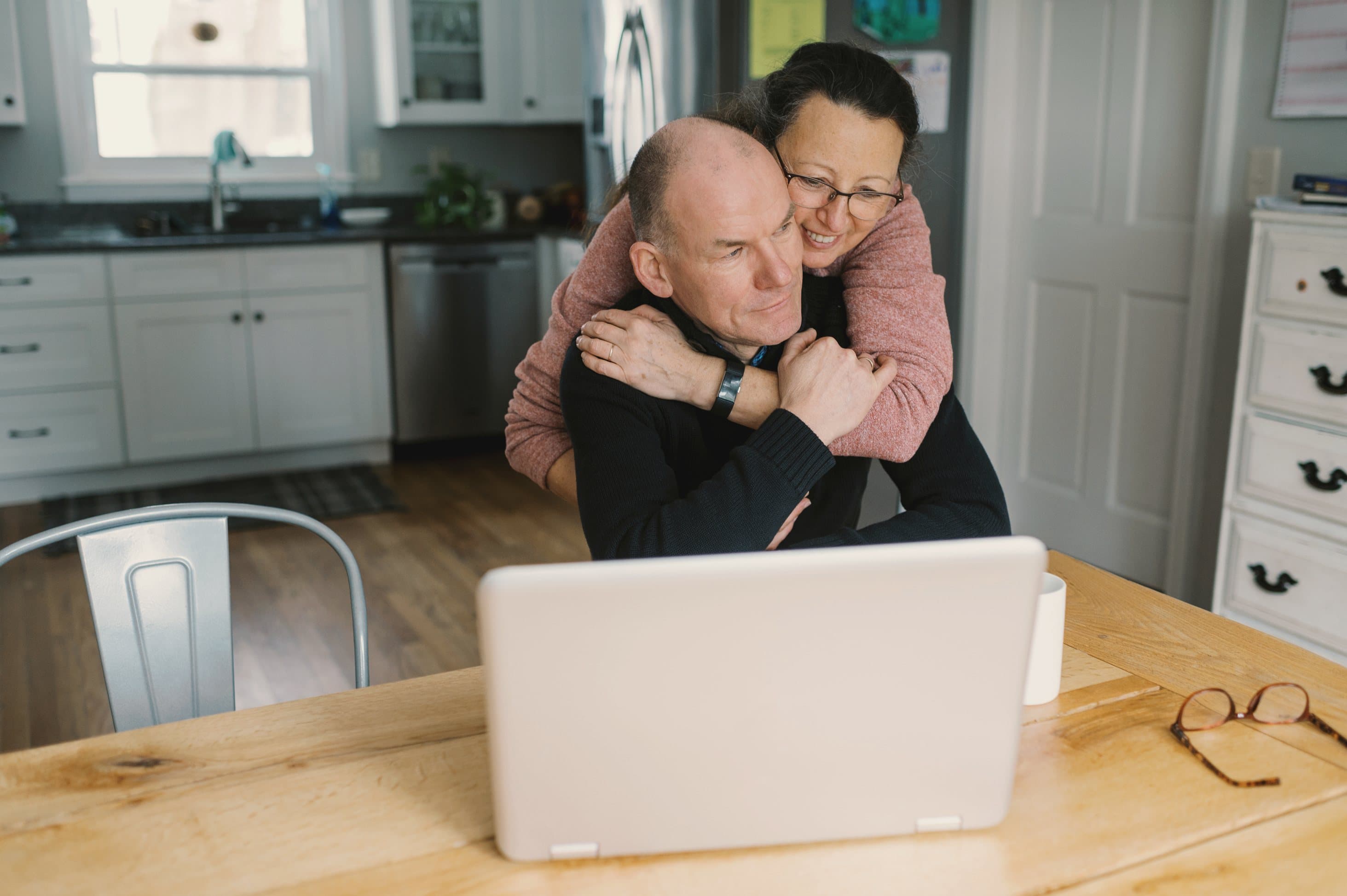 A couple reviewing finances together on a laptop at home